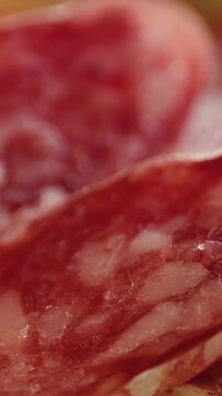 Mix of spanish pork sausages, Cutting board of appetizing catalonian snack - fuet, jamon, chorizo, olives, supermarket tapas food in spain, traditional cuisine. 