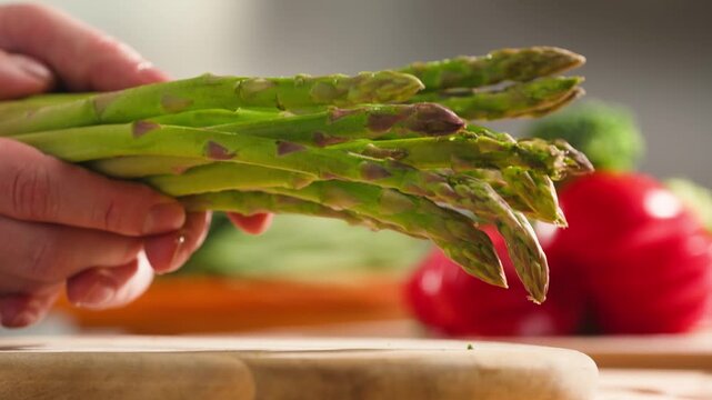 Fresh green asparagus on kitchen with broccoli and green pepper, vegan healthy food. Bunch of green asparagus close-up