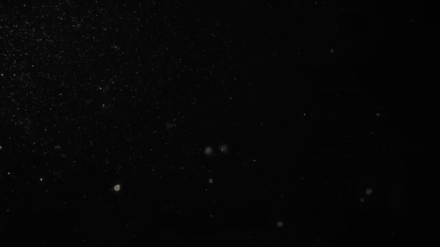 glowing particles drifting in dark void space