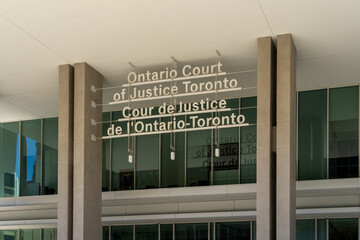 Fototapeta premium Toronto, Canada - August 5, 2026: The entrance to the Ontario Court of Justice building located on Armoury Street in Toronto, Canada. The Ontario Court of Justice is the provincial court of record.