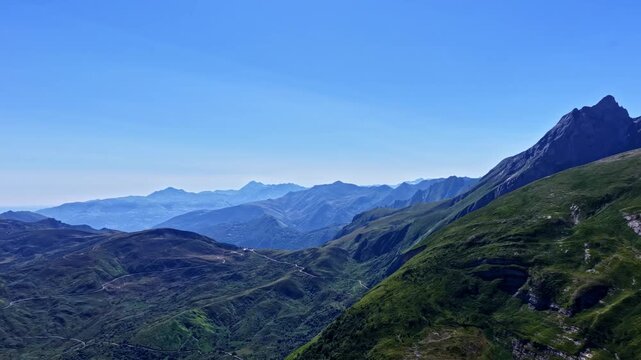 High altitude panorama across green ridges and rocky peaks near Col d'Aubisque in the Pyrenees mountains, France