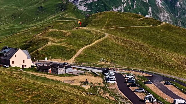 Paraglider flying above Col d'Aubisque in the French Pyrenees mountains on a sunny day