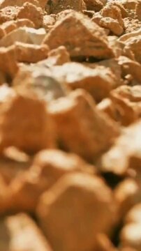 Close-up macro shot of weathered orange rocks in the desert