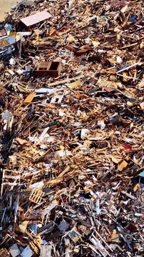 Aerial view reveals massive pile of scrap wood and broken pallets stacked at recycling site near Port of Bordeaux France