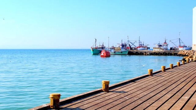 Quay at St Helena Bay Sandy Point Harbour with view of docked commercial vessels