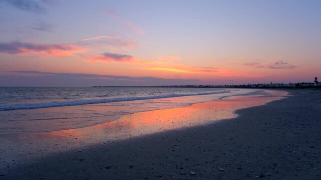 Serene waves lap onto Golden Mile beach at dawn with vibrant sky, Britannia Bay