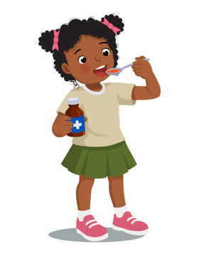 Sick African girl taking medicine syrup from a spoon
