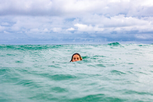 Girl swimming through rough water