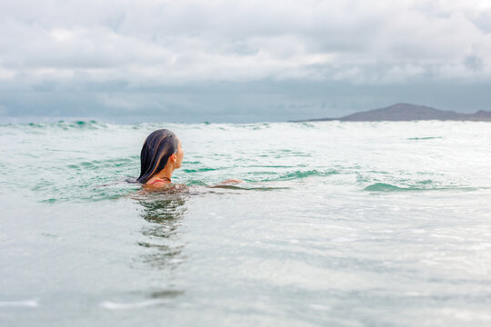 Lady looking out to sea while swimming