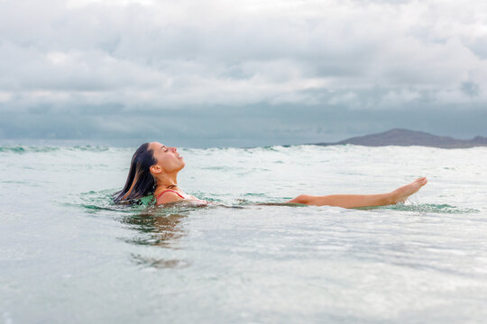 Woman taking a breath above water, Galapagos