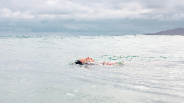 Woman swimming on back, relaxing