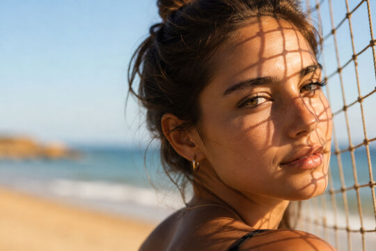 Young Woman with Beach Net Shadow Across Face in Golden Hour Coastal Portrait