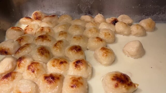 A tantalizing close-up shot of rich Baked Rosogolla&mdash;spongy cottage cheese balls baked in caramelized condensed milk (kheer) and served warm in a traditional clay pot, Kolkata, India