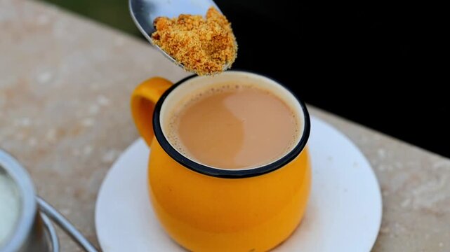 Spoon stirring jaggery gur sweetener inside cup of hot Pakistani chai milk tea 180fps Captured in Cinematic High Detail Footage