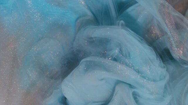 Sparkling underwater mix. Ink background. Blur blue orange color bright smoke splash glitter liquid texture spreading on art acrylic abstraction.