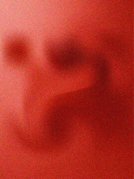 Soft red abstract with blurred darker red shapes and a grainy texture