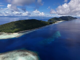 Aerial drone footage of a beautiful sandbar surrounded by crystal-clear turquoise water in Raja Ampat, Indonesia. The tropical seascape showcases pristine white sand, shallow waters, and the natural b © Andri Pradana