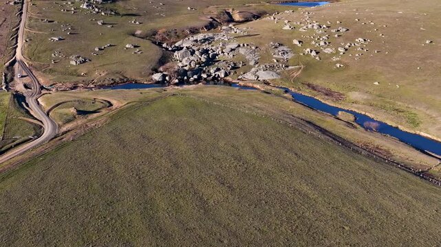 Aerial View of Rural Landscape with Granite Boulders and Dirt Road
