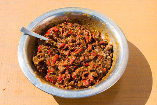 homemade red chilli that is lal mirch ka achar in outside natural sunlight.