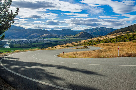 Road, car background, automotive backplate, sealed mountain road with dramatic skies and mountain landscape behind