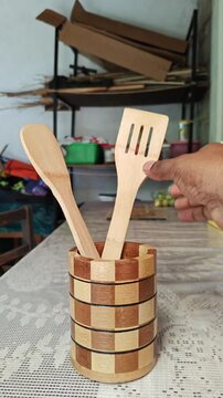 Hands Grabbing Set of Handcrafted Bamboo Kitchen Spatulas