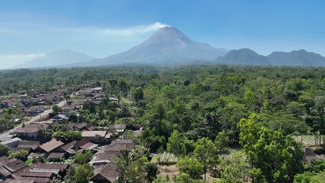 Aerial footage of Mount Merapi and Mount Merbabu in the morning. Blue skies and clear weather. Tropical landscape.