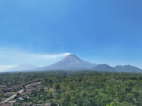 Aerial photo of Mount Merapi and Mount Merbabu in the morning. Blue skies and clear weather. Tropical landscape.