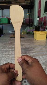 Close Up Shot of Handcrafted Bamboo Cooking Spoon on Wooden Table
