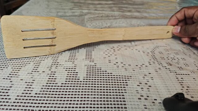Flat Bamboo Spatula Resting on Wooden Table Top View