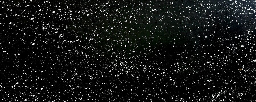 Abstract white paint splatter on black background, white dots spray texture, space stars texture, galaxy background pattern.
