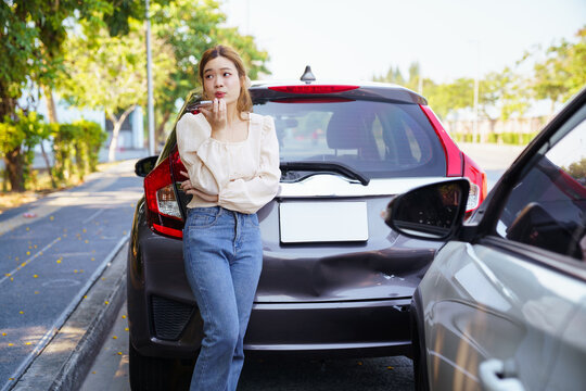 Worried Asian woman calling roadside assistance on mobile phone