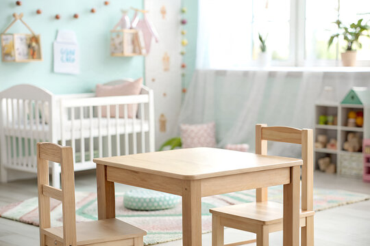 Small wooden table and matching chairs standing inside a bright nursery room with soft mint walls and a white crib in the cozy blurred background