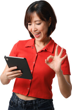 Asian woman smiling while holding tablet and making approval gesture against transparent background
