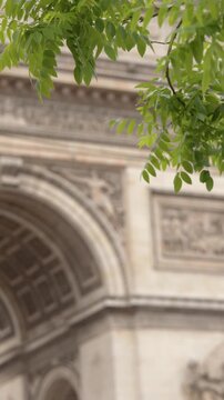 Arc de Triomphe Monument Viewed Through Green Tree Leaves in Paris