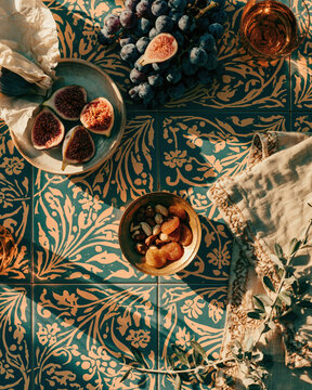 Top view of dried fruits and nuts on ornate teal floral fabric