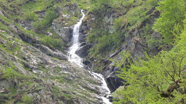Waterfall Cascading Down Rocky Cliff at Lago della Rovina, Italy