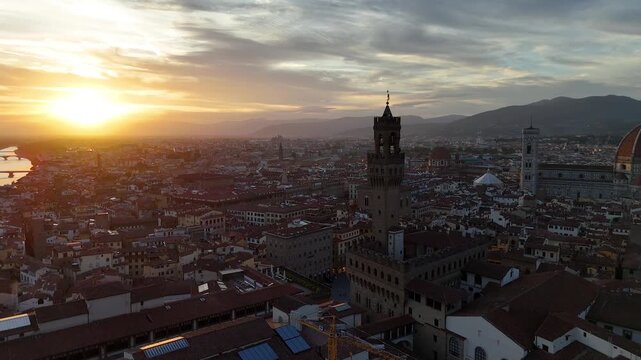 Florence, Italy. Aerial 4K panoramic drone view of the city at sunset or sunrise. Majestic view of the ancient city skyline with basilics, Palazzo Vecchio, bridges, iconic buildings. Europe from above