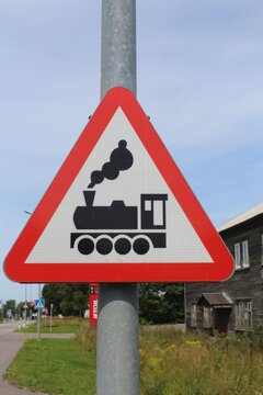 Red Triangular Railway Level Crossing Warning Sign with Steam Train Silhouette