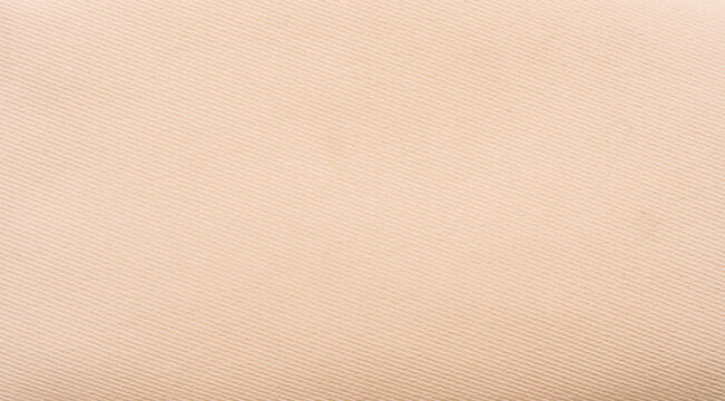 Plain beige fabric texture with soft textile surface, minimal neutral background.