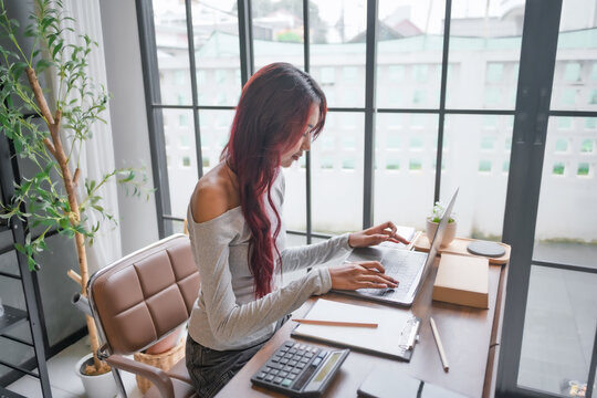 Woman managing ecommerce business with laptop for online sales logistics and digital commerce.