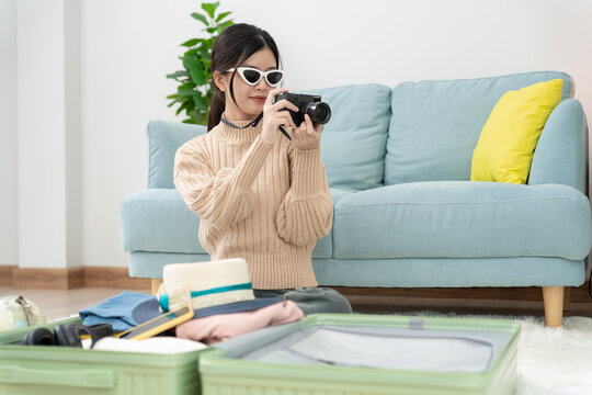 Holiday calendar for travel, Traveler, travel bag. choose country for travel. Asian Young women are prepare clothes and personal belongings. Pack your luggage before travel, Travel, life style