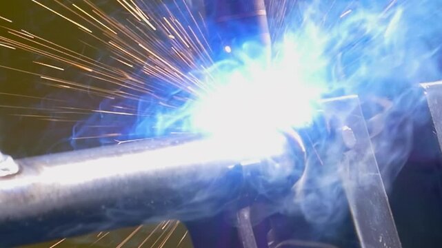 An advanced argon welding robot expertly fuses metal pipes together. Bright sparks light up the workspace as molten metal flows seamlessly, showcasing high-tech craftsmanship in an industrial setting.