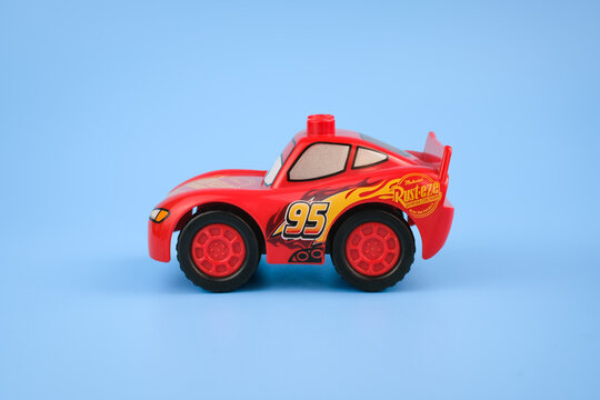 Side profile of a Lightning McQueen toy car displayed on a light blue background, showing the racing graphics, number 95, and red wheels on Jul 29, 2026 in Jakarta, Indonesia