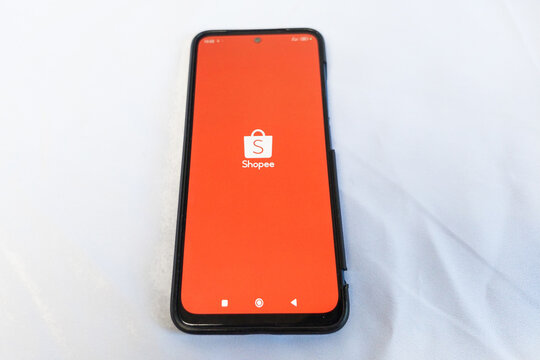 Makassar, Indonesia, August 06, 2026, Shopee logo on a mobile phone screen against a white background.