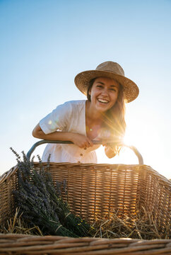 Woman holding wicker basket lavender golden hour outdoor field