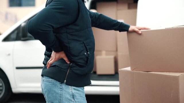 Logistics, delivery or man with back pain, spine issue or labor injury in outdoor distribution. Strain, burnout or courier at van with packages, backache massage or muscle discomfort in supply chain.