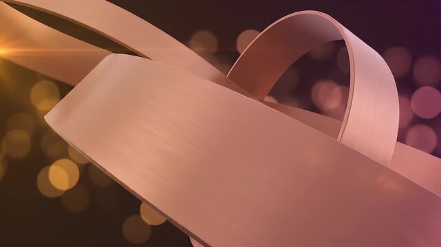 Abstract rose gold ribbons intertwined against bokeh background
