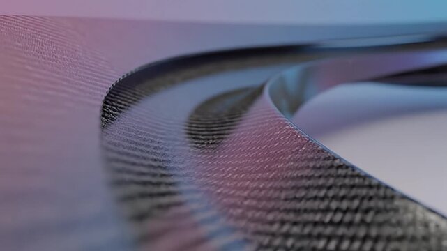 Closeup view of a textured curved surface with a gradient of purple and blue light