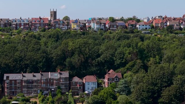 Drone rises over Emmanuel Church on Priory Road, Hastings, creating a parallax effect as rooftops and hills unfold below.