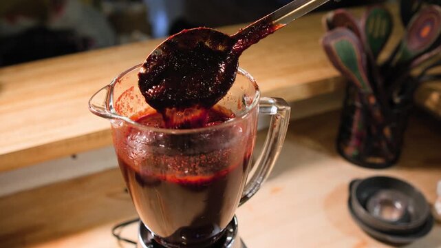Close up cooking footage showing checking the viscosity of the chamoy sauce during a homemade chamoy sauce recipe prepared from scratch